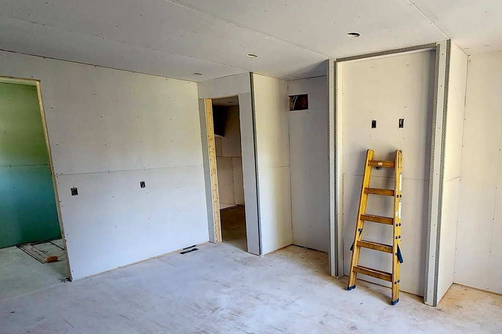 Commercial Drywall Installation in Toronto – unfinished room with drywall sheets by Express Drywall Services