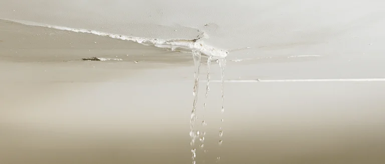Water leaking from a cracked drywall ceiling due to severe water damage – Express Drywall Services