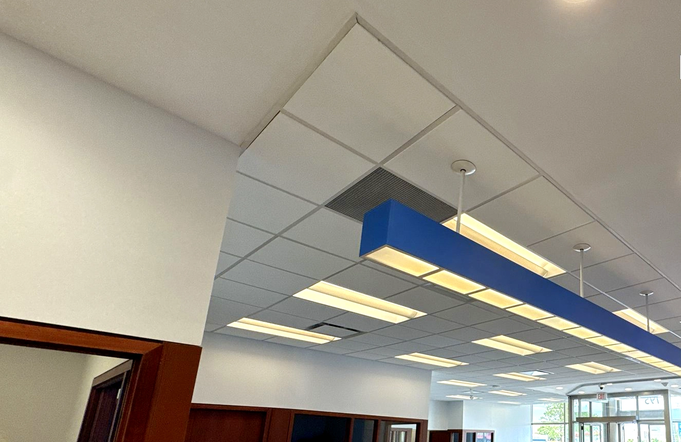 Commercial T-Bar and Drop Ceilings in Toronto with blue suspended lighting – Express Drywall Services
