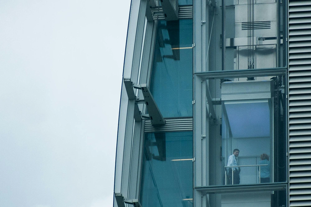 High-rise elevator with visible shaft wall structure by Express Drywall Services in Toronto.