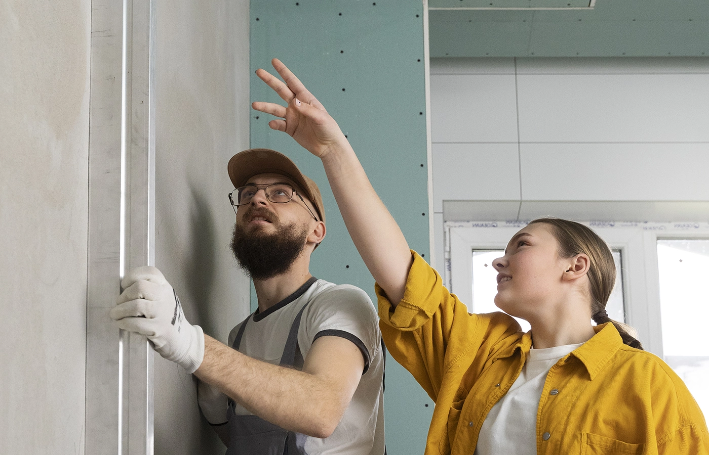 Two contractors discussing drywall installation details, showing the value of working with the right framing and drywall partner at Express Drywall Services.