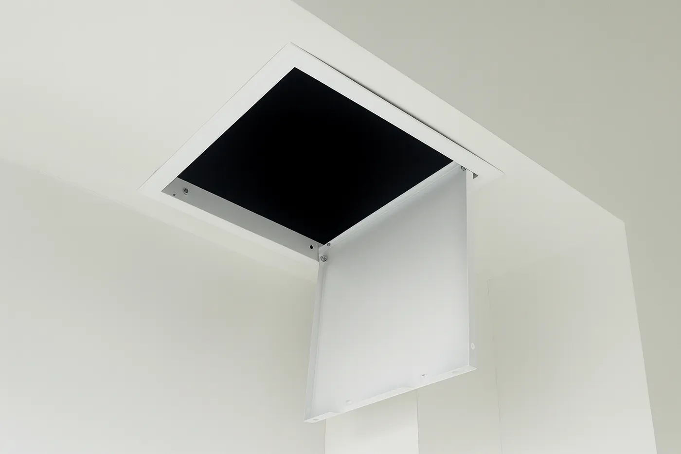 Ceiling access door partially open during professional access door installation in Richmond Hill.