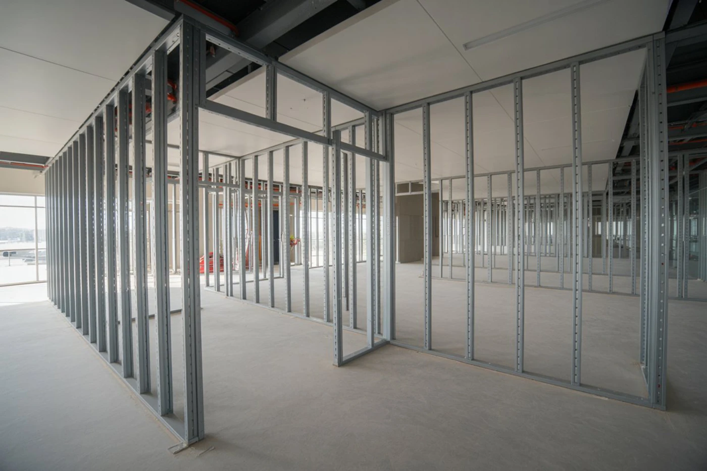 Commercial unit under renovation with drywall installation and exposed ductwork – best drywall solutions GTA.