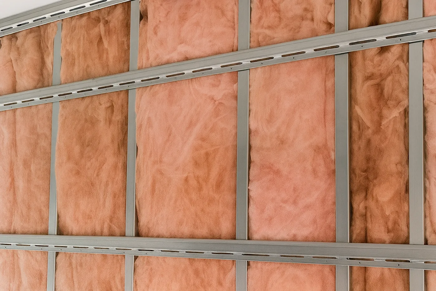 Commercial resilient channel installation in Richmond Hill – metal framing wall system with pink insulation and horizontal resilient channels.