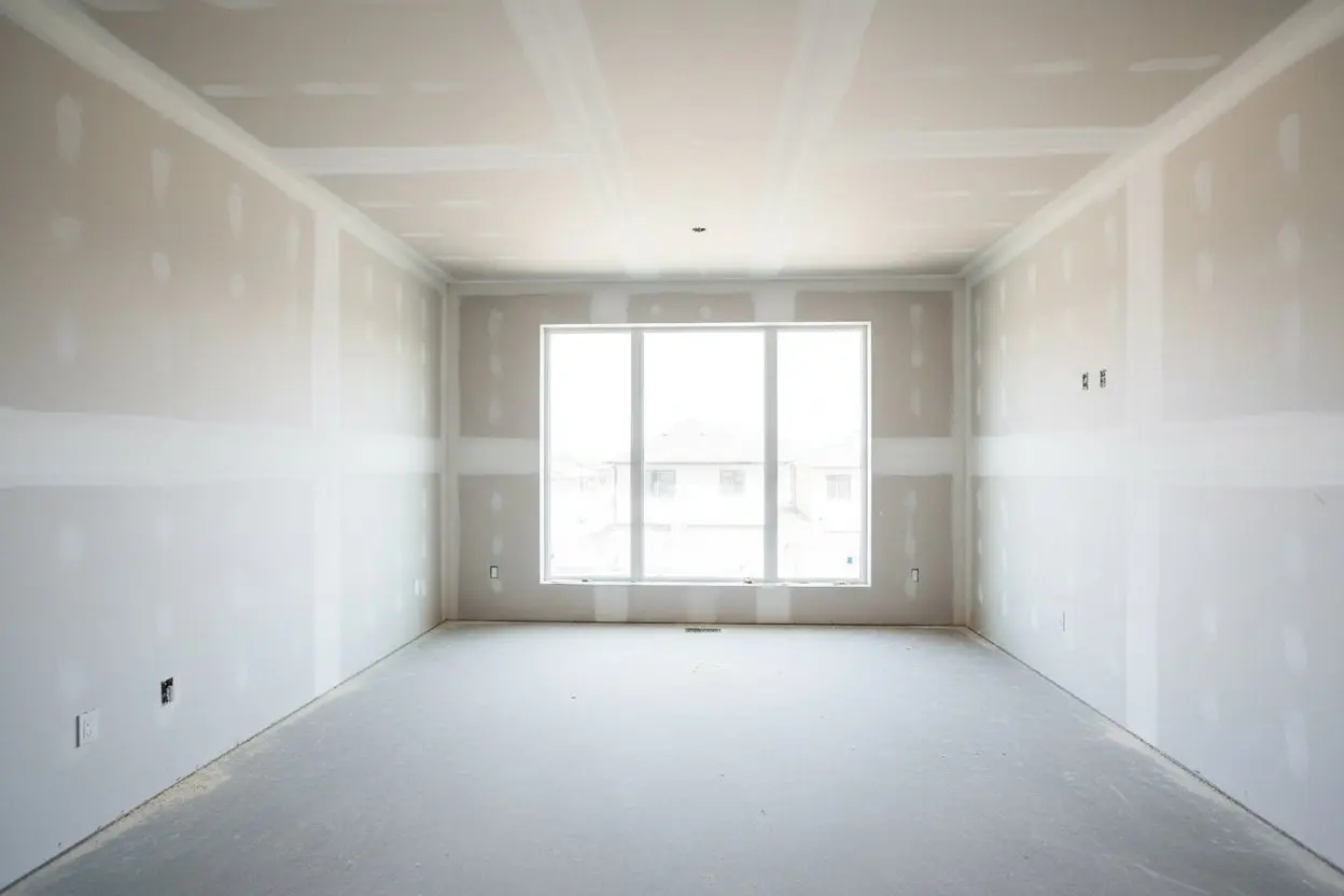 Express Drywall Services performing drywall installation in Whitby in a large room with clean taped joints and a central window