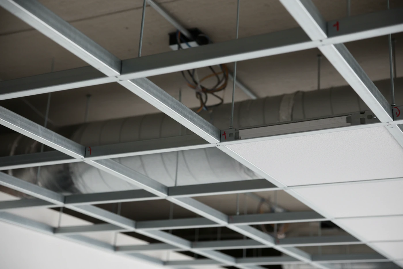 installating drop ceiling tiles with exposed grid system by Express Drywall Services