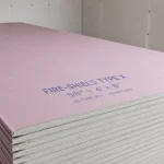 Stack of 5/8 inch Fire-Shield Type X drywall panels, UL Type SCX, ASTM C1396 certified, pink face paper, gypsum core edge detail visible